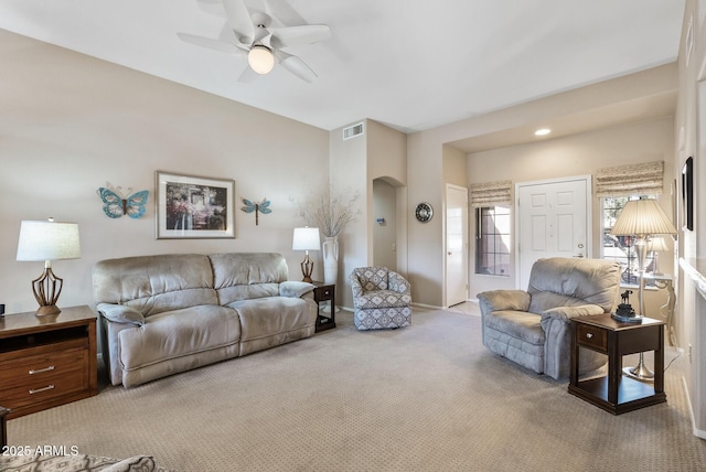 carpeted living room featuring ceiling fan