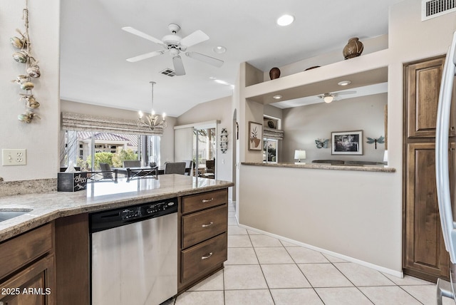 kitchen with vaulted ceiling, light tile patterned floors, stainless steel dishwasher, ceiling fan with notable chandelier, and light stone countertops