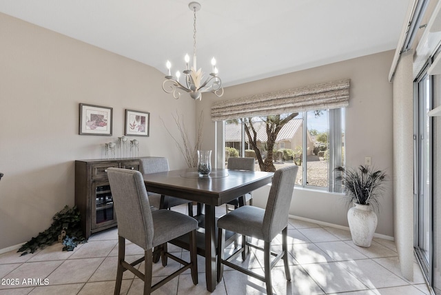 dining area featuring vaulted ceiling, an inviting chandelier, and light tile patterned flooring