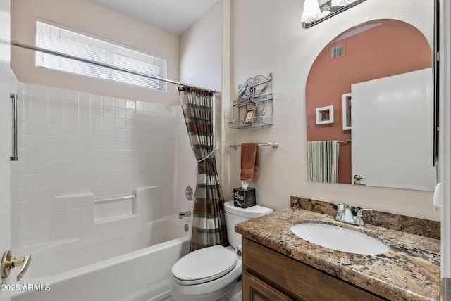 full bathroom featuring vanity, shower / bath combo with shower curtain, and toilet