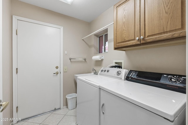 laundry area with cabinets, light tile patterned flooring, and separate washer and dryer