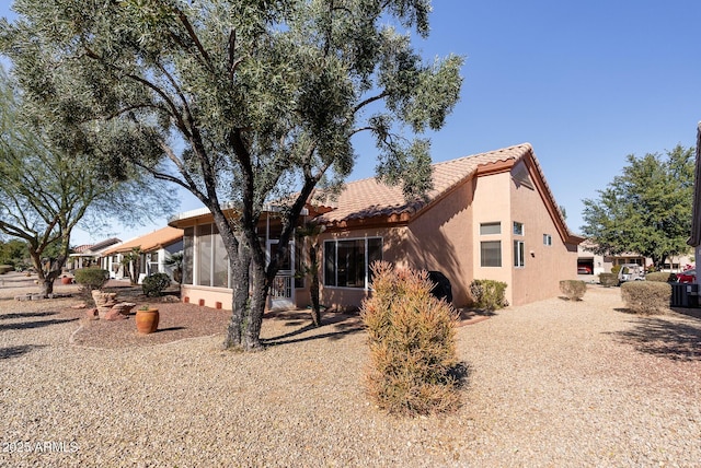 back of house featuring a sunroom