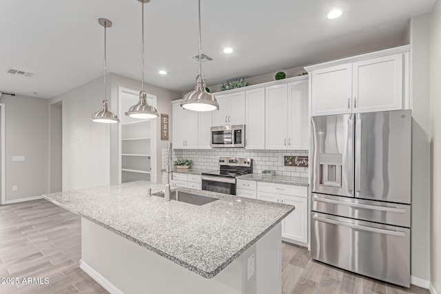 19873 W San Juan Ave, Litchfield Park, AZ 85340 - kitchen featuring appliances with stainless steel finishes, a sink, white cabinets, light wood-style flooring, and recessed lighting