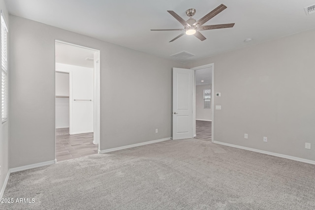 19873 W San Juan Ave, Litchfield Park, AZ 85340 - unfurnished bedroom featuring carpet, baseboards, a walk in closet, and ceiling fan