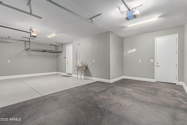 19873 W San Juan Ave, Litchfield Park, AZ 85340 - garage featuring a garage door opener and baseboards