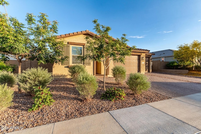 19873 W San Juan Ave, Litchfield Park, AZ 85340 - view of front of property with decorative driveway, stucco siding, an attached garage, and a tiled roof