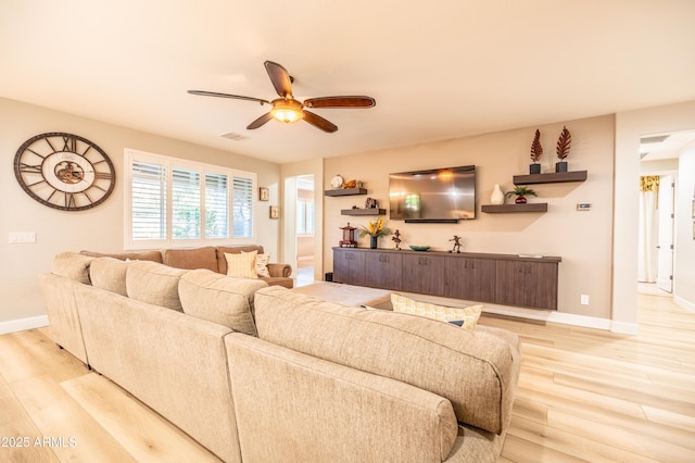 living area with light wood-style floors, visible vents, baseboards, and a ceiling fan