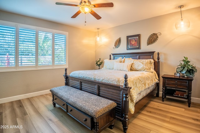 bedroom with baseboards, ceiling fan, and light wood finished floors