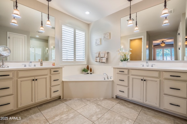 bathroom featuring two vanities, a sink, a garden tub, and tile patterned floors