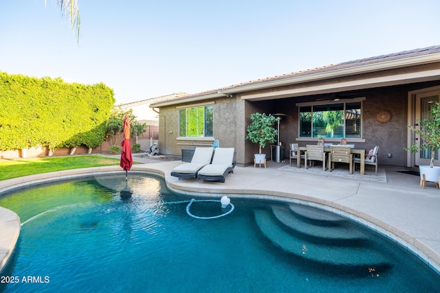 outdoor pool with a ceiling fan, outdoor dining area, a patio area, and a fenced backyard