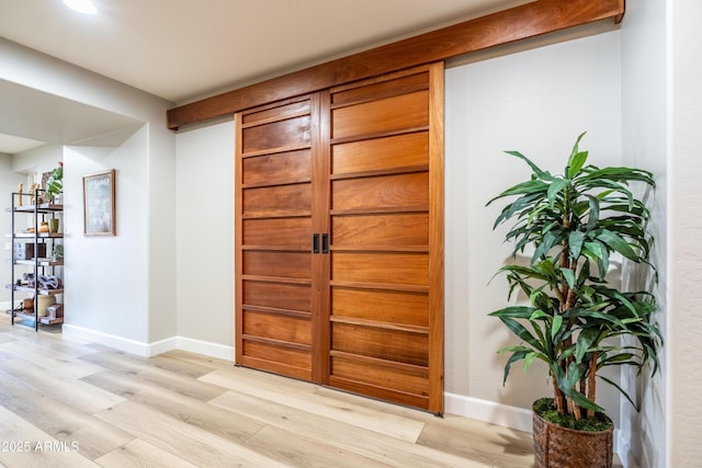 foyer entrance featuring light wood finished floors and baseboards