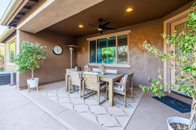 view of patio with outdoor dining area and a ceiling fan