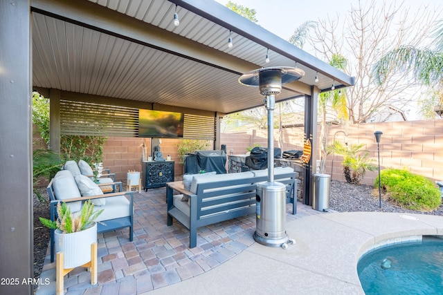 view of patio with an outdoor hangout area, grilling area, and fence