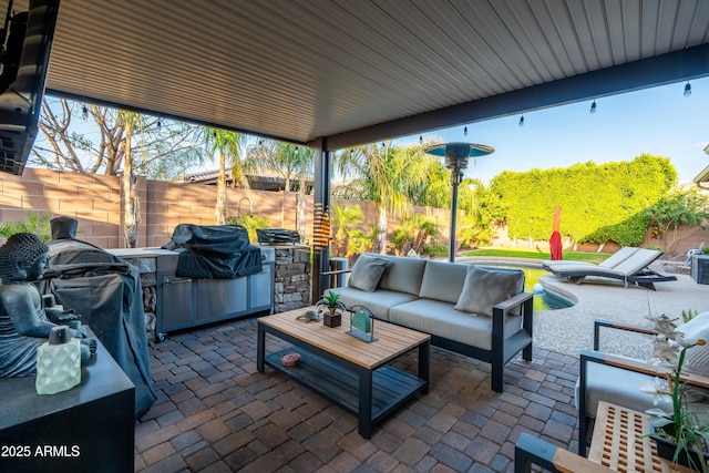 view of patio / terrace with a fenced backyard, an outdoor hangout area, and area for grilling