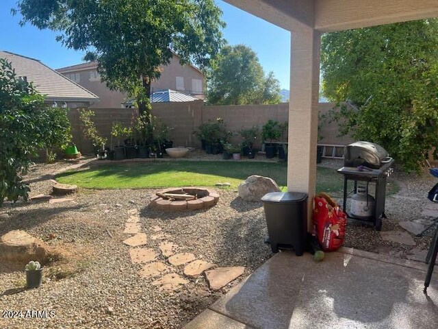 view of yard with an outdoor fire pit