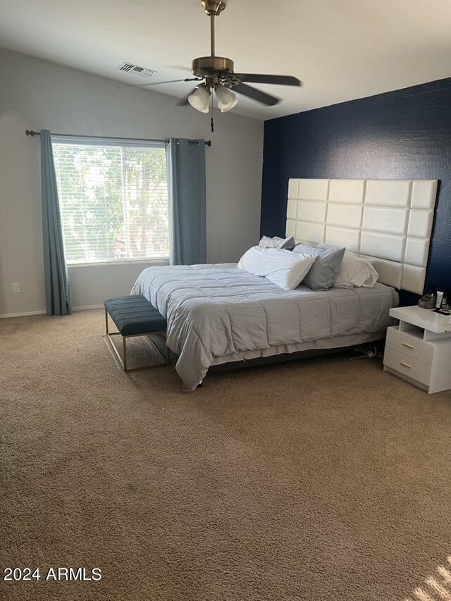 bedroom featuring ceiling fan and carpet