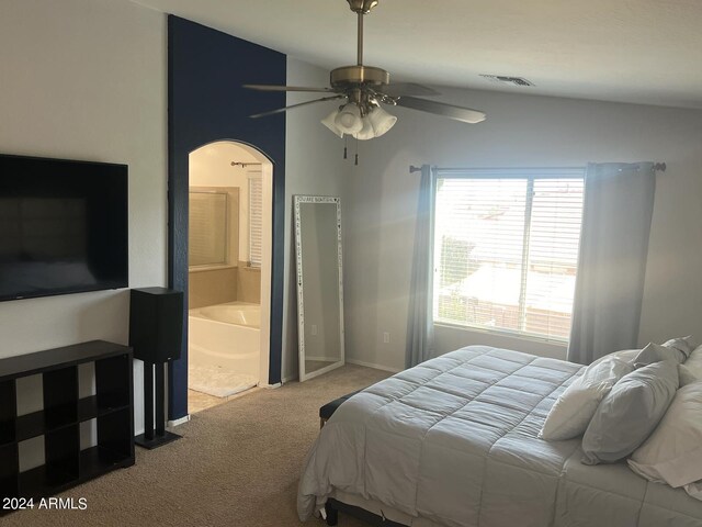 bedroom featuring lofted ceiling, ceiling fan, light colored carpet, and ensuite bath