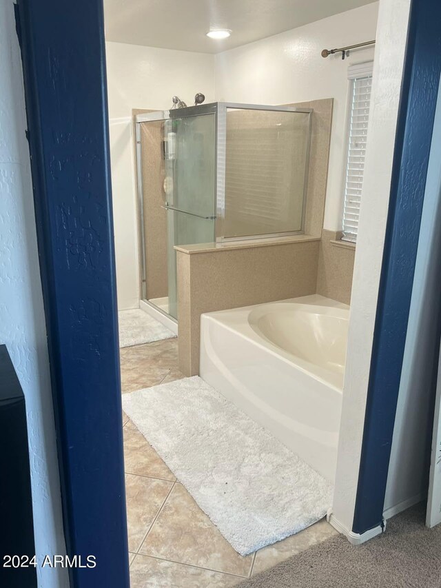 bathroom with tile patterned flooring and independent shower and bath