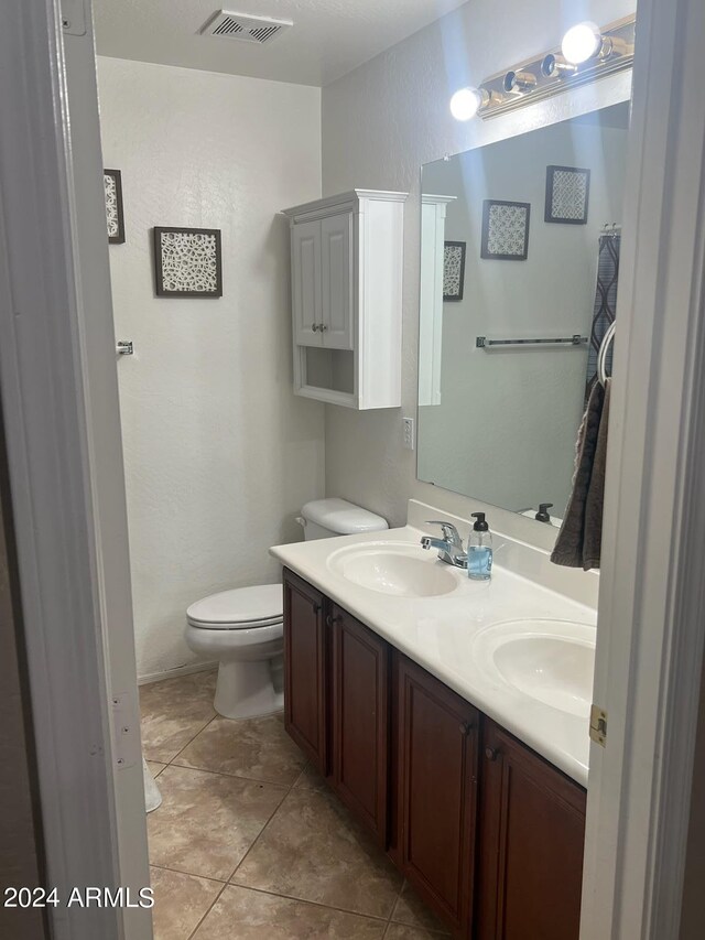 bathroom featuring vanity, toilet, and tile patterned floors