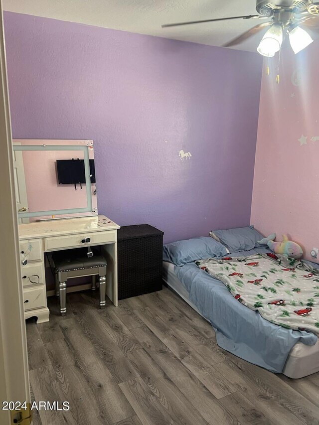 bedroom featuring ceiling fan and dark hardwood / wood-style flooring