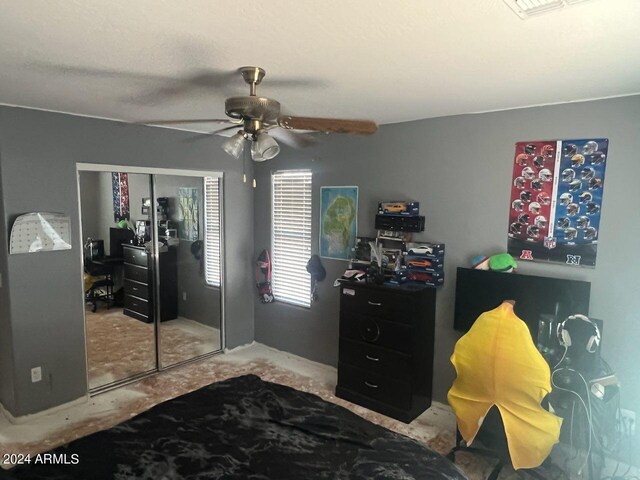 bedroom with ceiling fan and a closet