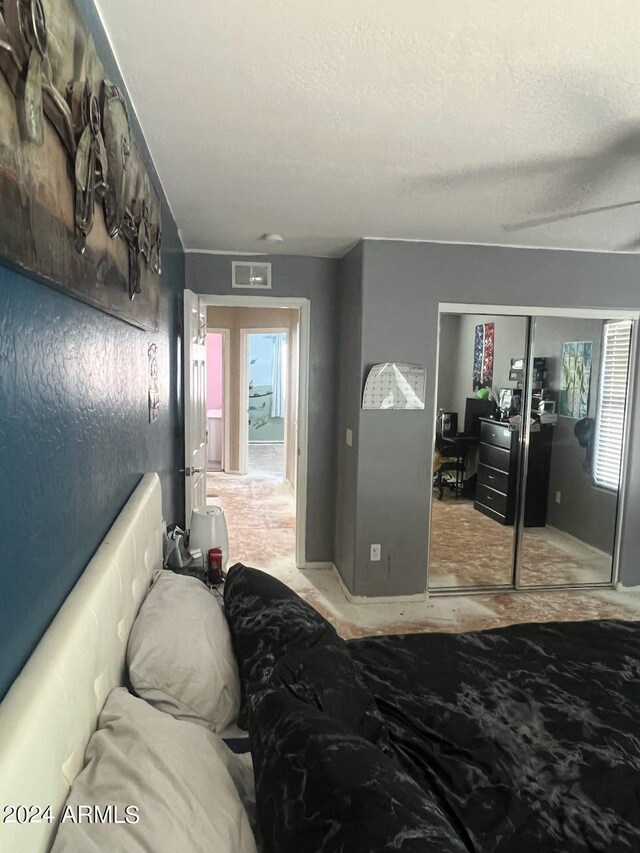 bedroom featuring a textured ceiling and a closet