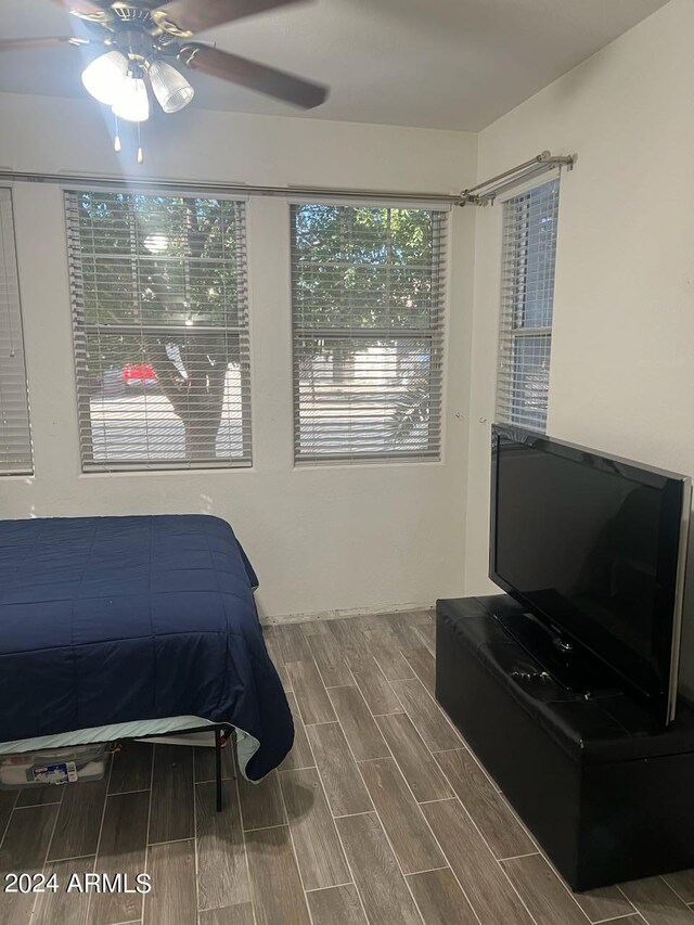 bedroom with ceiling fan and hardwood / wood-style floors