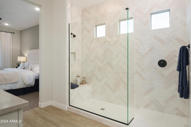 ensuite bathroom featuring recessed lighting, a stall shower, connected bathroom, and wood finished floors