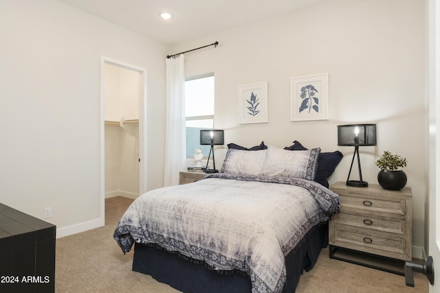 carpeted bedroom with recessed lighting, a closet, a walk in closet, and baseboards