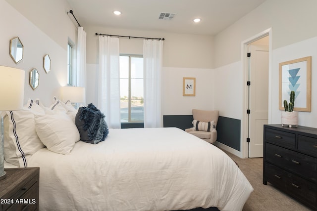 bedroom with baseboards, visible vents, light carpet, and recessed lighting