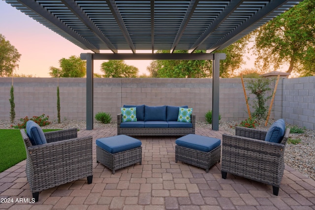 patio terrace at dusk with a pergola, an outdoor living space, and a fenced backyard