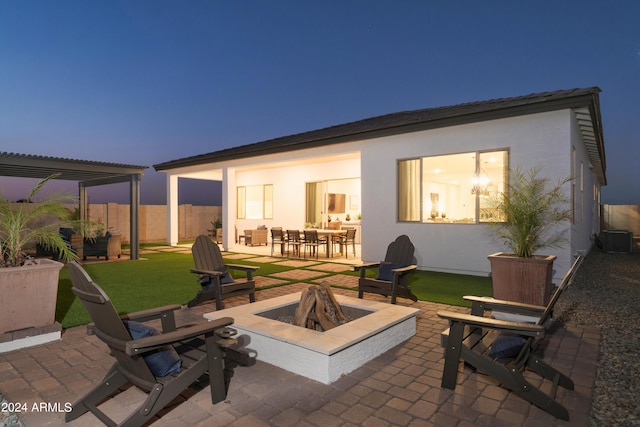 back of house featuring an outdoor fire pit, fence, stucco siding, and a patio area