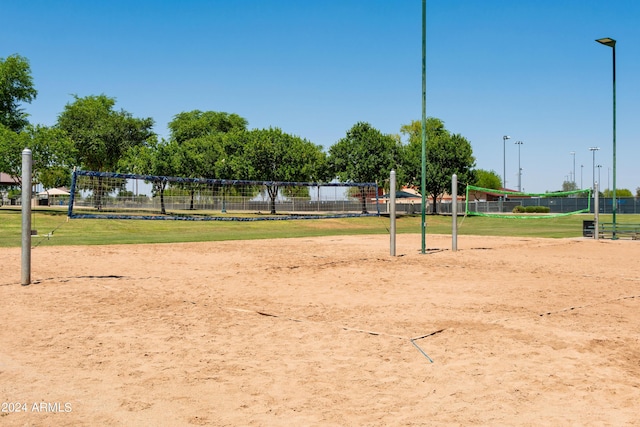 surrounding community with fence and volleyball court