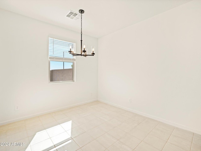 unfurnished dining area with a chandelier and light tile patterned floors