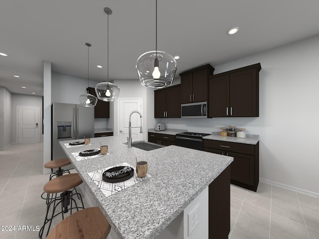 kitchen with sink, appliances with stainless steel finishes, pendant lighting, and an island with sink