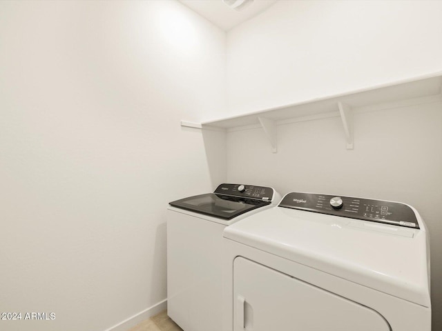 clothes washing area with washing machine and clothes dryer