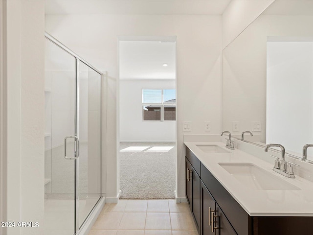 bathroom with vanity, a shower with shower door, and tile patterned flooring