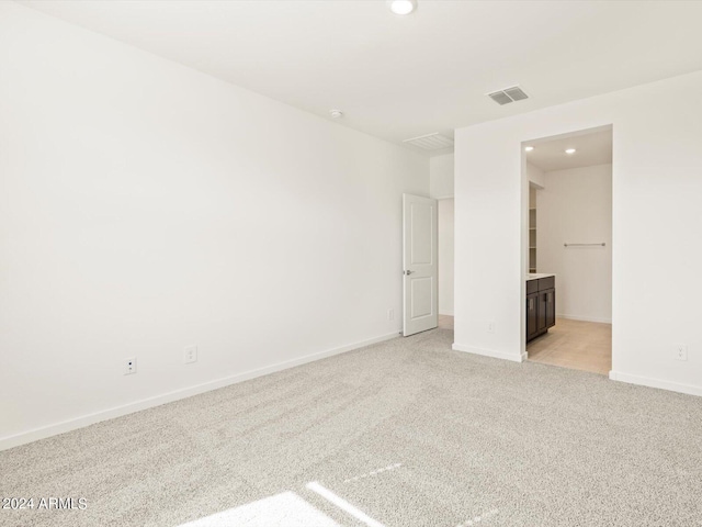 empty room featuring light colored carpet