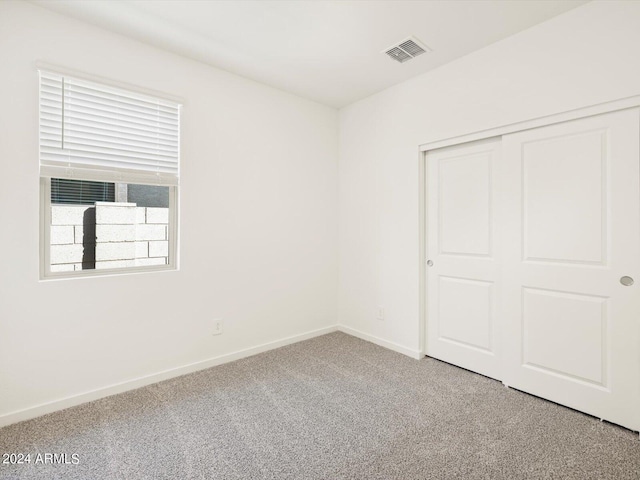 unfurnished bedroom featuring a closet and carpet flooring