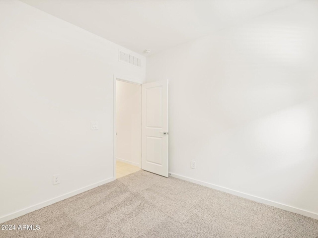 spare room with light colored carpet