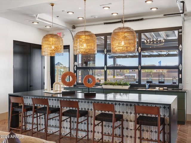 bar featuring decorative light fixtures and hardwood / wood-style floors