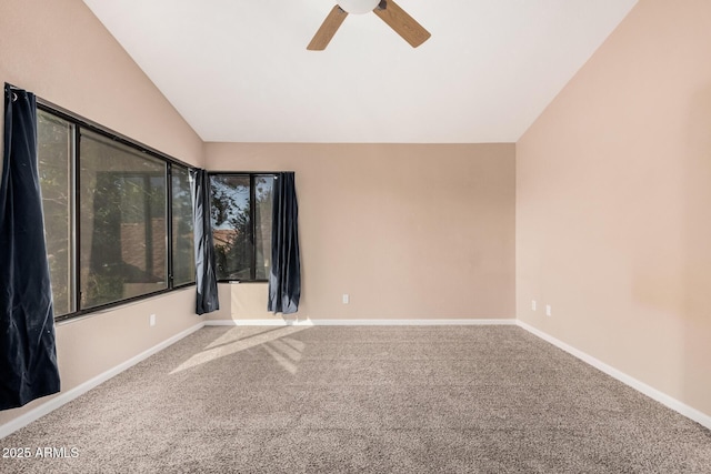 spare room with baseboards, lofted ceiling, carpet, and ceiling fan