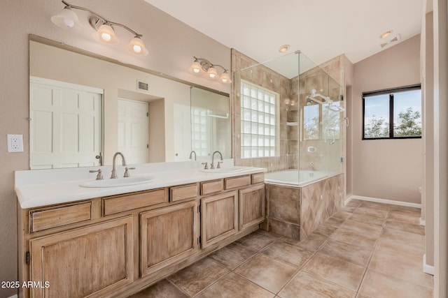 bathroom featuring tile patterned floors, plenty of natural light, and a sink