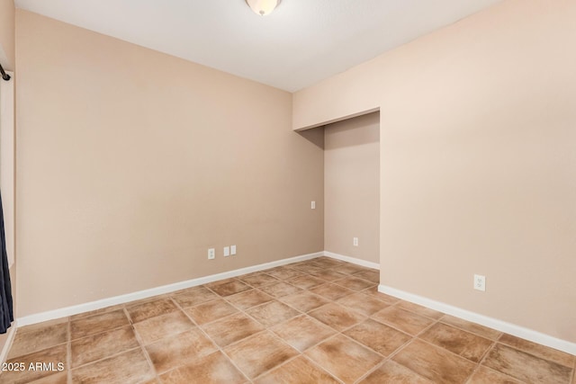 interior space with light tile patterned floors and baseboards