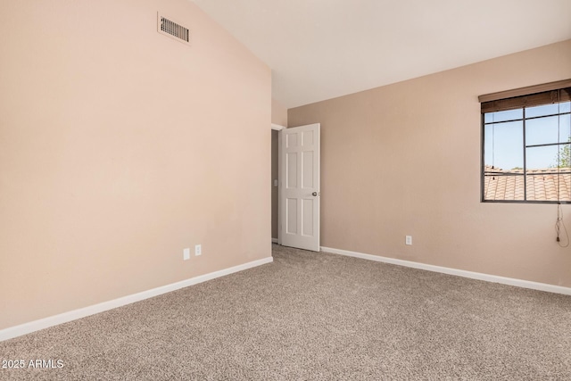 unfurnished room with visible vents, baseboards, lofted ceiling, and carpet flooring