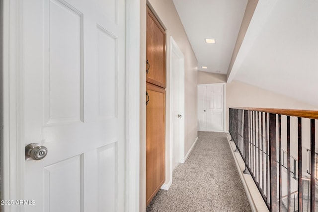 hallway with light carpet and baseboards