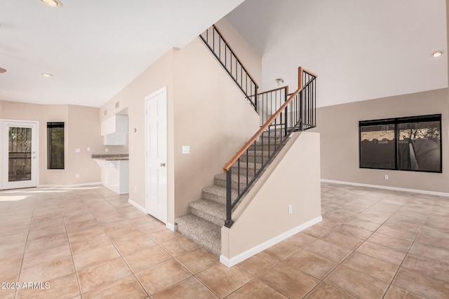 stairs with tile patterned floors, recessed lighting, and baseboards