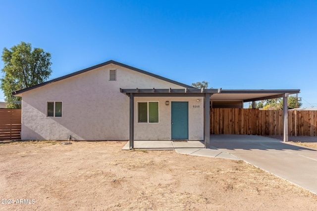 ranch-style home featuring a carport and a patio area