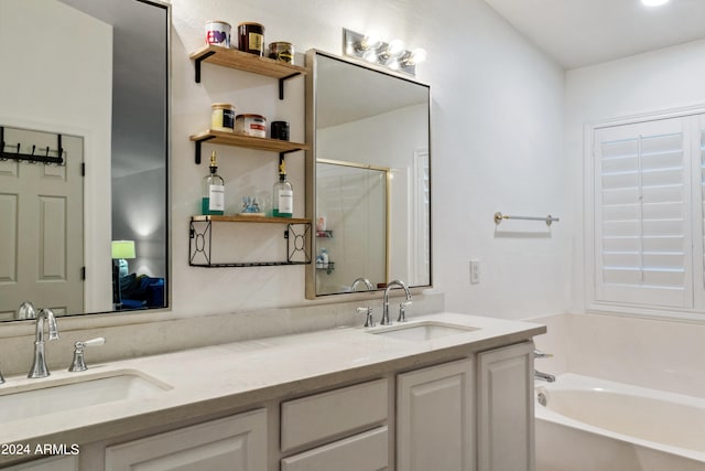 bathroom with vanity and shower with separate bathtub