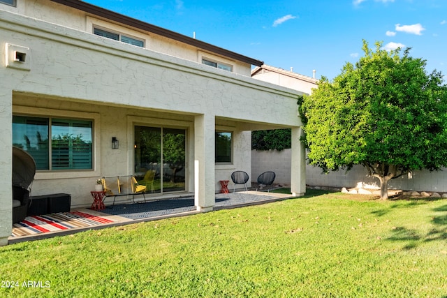 back of house with a lawn